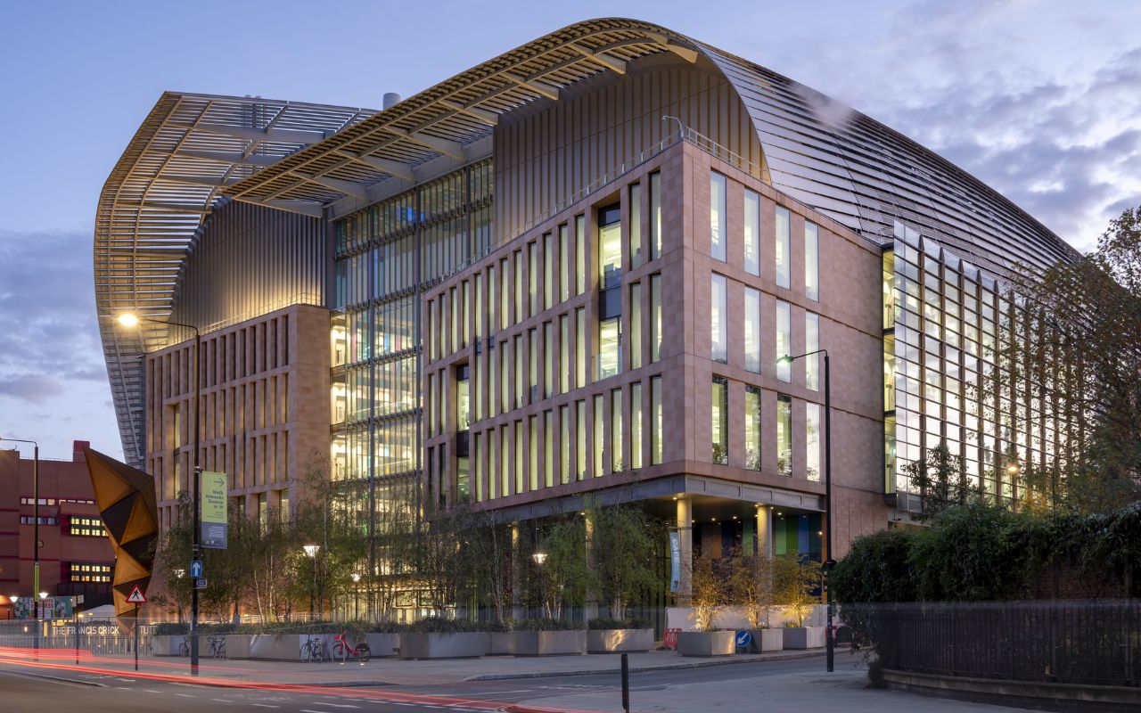 Photograph of Francis Crick Institute, a large modern building with a curved roof and lots of glass windows